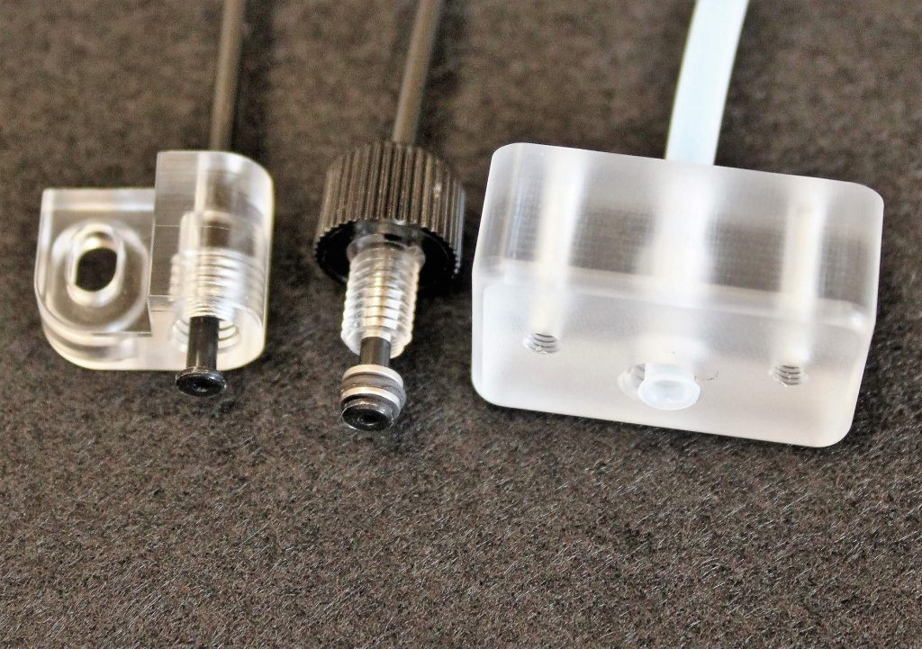 Three Flared Plastic Tubes Assembled with Fittings Used in Life Sciences