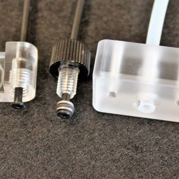 Three Flared Plastic Tubes Assembled with Fittings Used in Life Sciences