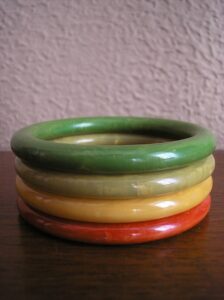 Image of Bakelite bangles in greens, yellows, and reds. 